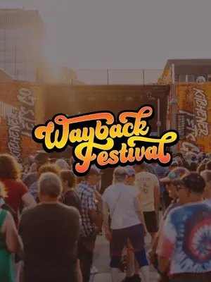 Wayback festival logo, with people watching a concert in the background 
