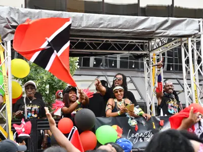 Crowd outside at festival holding up flags